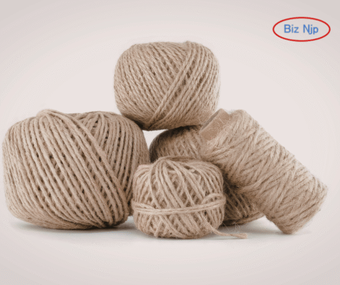 High-tensile 24lbs 3-ply CB grade jute yarn wound on industrial mackrolls for heavy-duty cable filling and structural reinforcement.